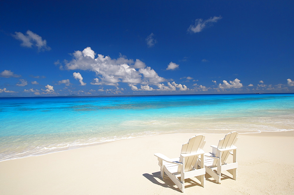 Two deck chairs on tropical beach facing sea, Maldives, Indian Ocean, Asia