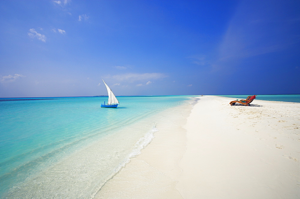 Dhoni and lounge chairs on tropical beach, Maldives, Indian Ocean, Asia