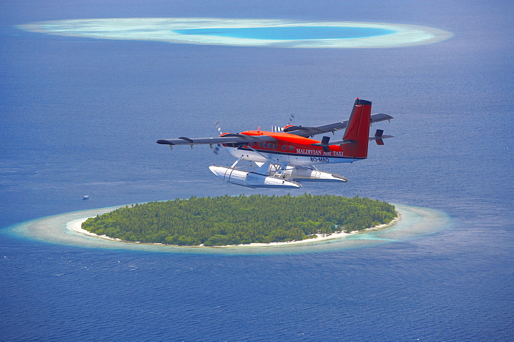 Maldivian Air Taxi flying above island, Maldives, Indian Ocean, Asia