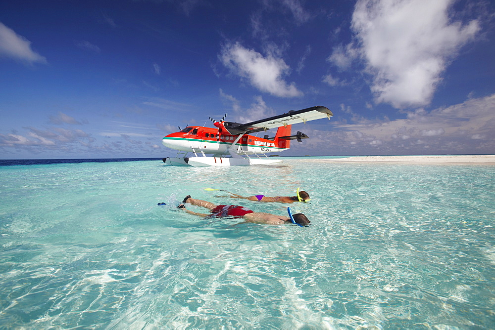 Seaplane and couple snorkeling, Maldives, Indian Ocean, Asia