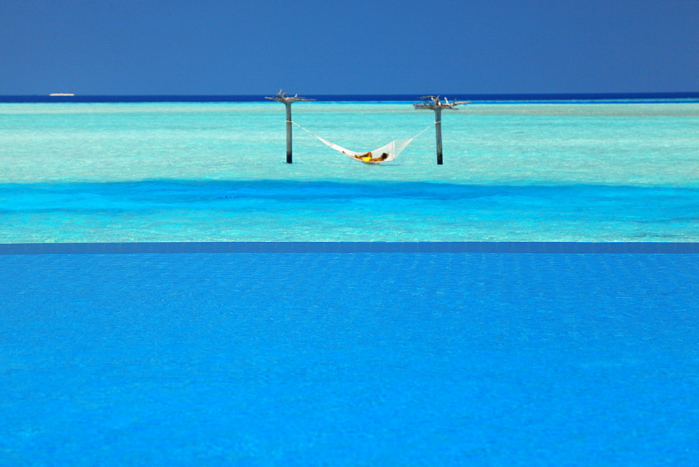 Infinity pool and hammock in lagoon, Maldives, Indian Ocean, Asia