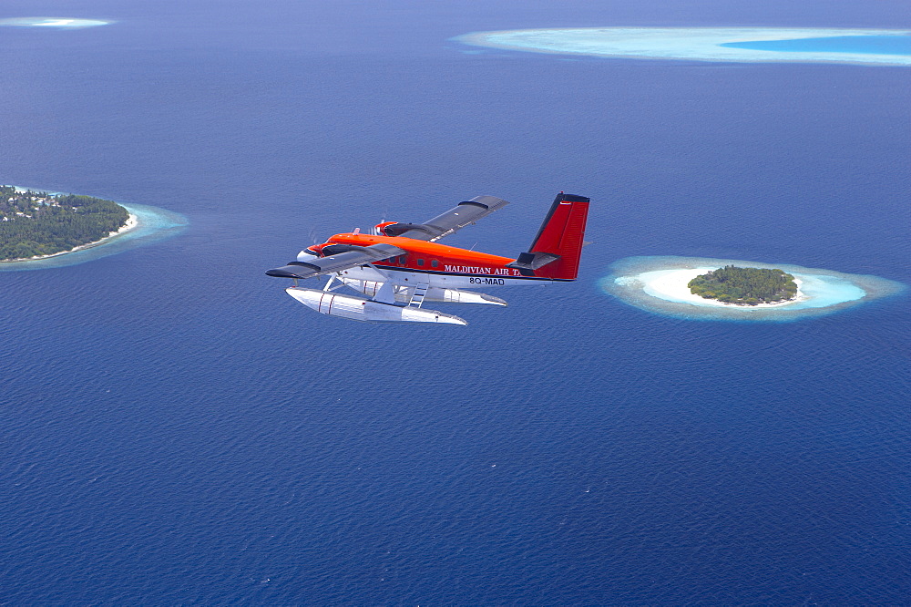 Aerial view of Maldivian air taxi flying above islands in the Maldives, Indian Ocean, Asia