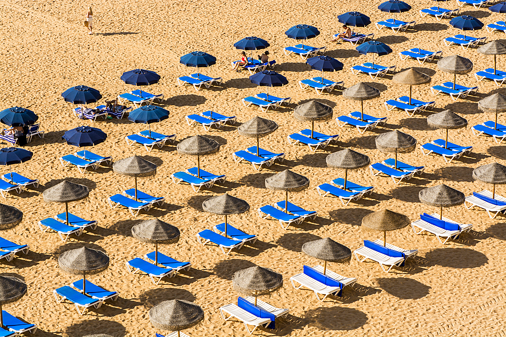 Beachgoers and umbrellas at Praia dos Pescadores or Fishermans Beach, Albufeira, faro district, algarve, portugal, europe.