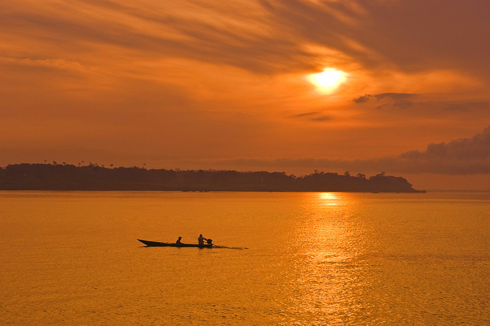 Fishermen at sunset on the Amazon River, Brazil, South America