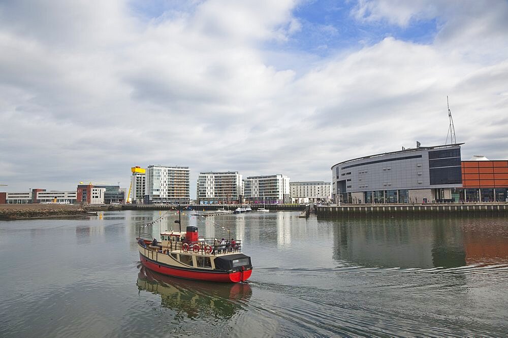 Ireland, North, Belfast, Titanic Quarter, tour boat taking tourists on sightseeing cruise.