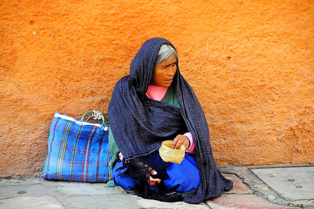 Mexico, Bajio, San Miguel de Allende, Woman begging on street corner.