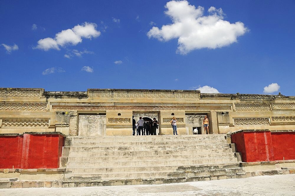 Mexico, Oaxaca, Mitla, Archaeological site Templo de las Columnas with tourist visitors standing at top of steps to entrance.