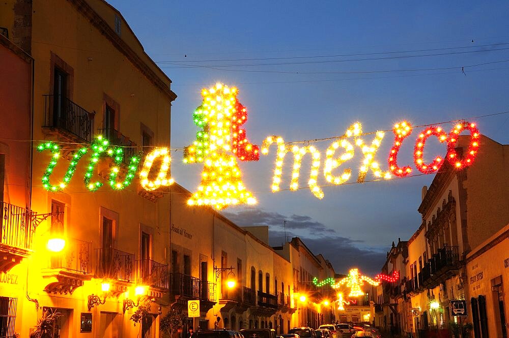 Mexico, Bajio, Zacatecas, Coloured lights hung across street for Independence Day celebrations.