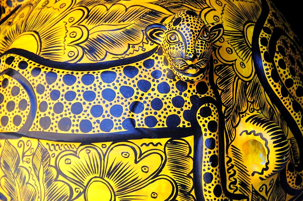 Mexico, Oaxaca, Detail of ceramic pot depicting spotted big cat in black and yellow.