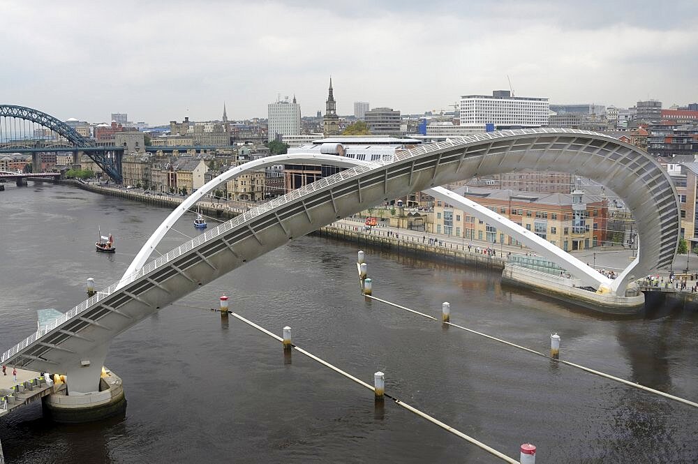 England, Tyneside, Gateshead, Millennium Bridge in open position from the Baltic Arts Centre looking towards Newcastle Quayside and Newcastle upon Tyne city.