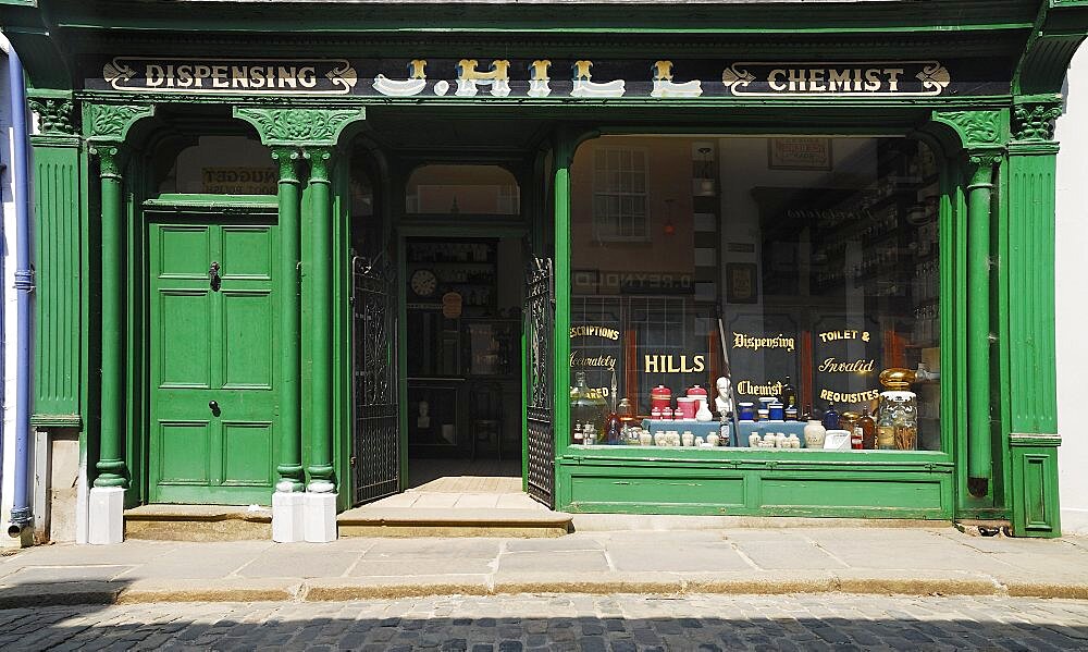 Ireland, County Tyrone, Omagh, Ulster American Folk Park 19th century street Hills chemist shopfront.