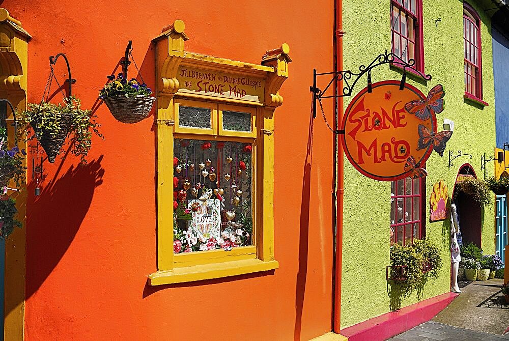 Ireland, County Cork, Kinsale, Colourful facades in market place with flower pots.