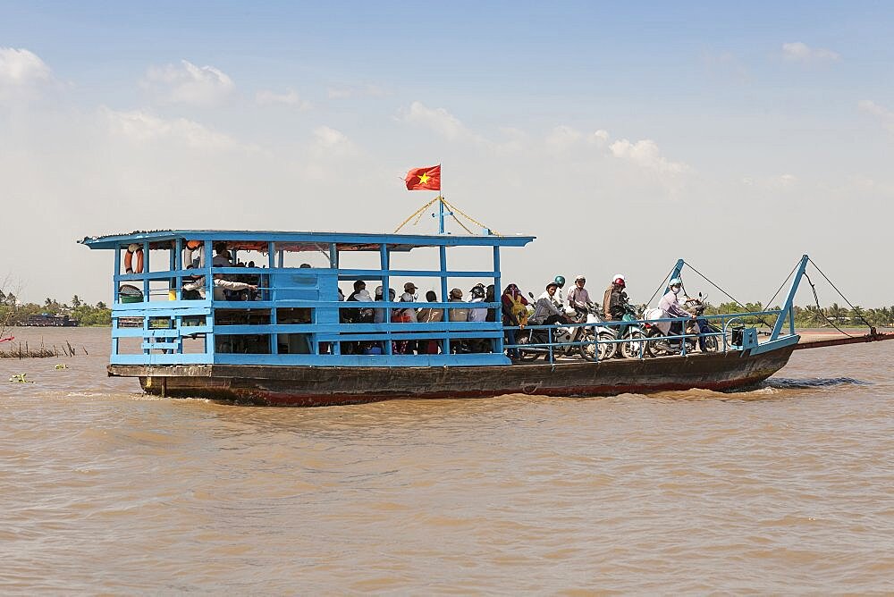 Vietnam, Mekong Delta, Cai Be, Passengers commuting on a small ferry boat.