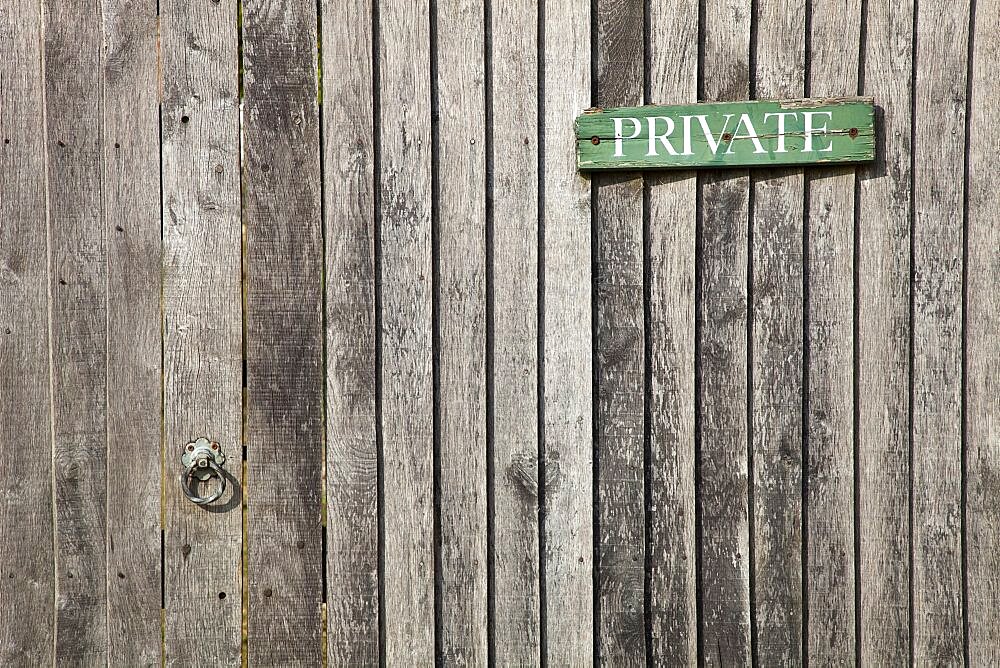 England, West Sussex, Chichester, Architecture Doors Detail of wooden gate and fence with priavte sign.