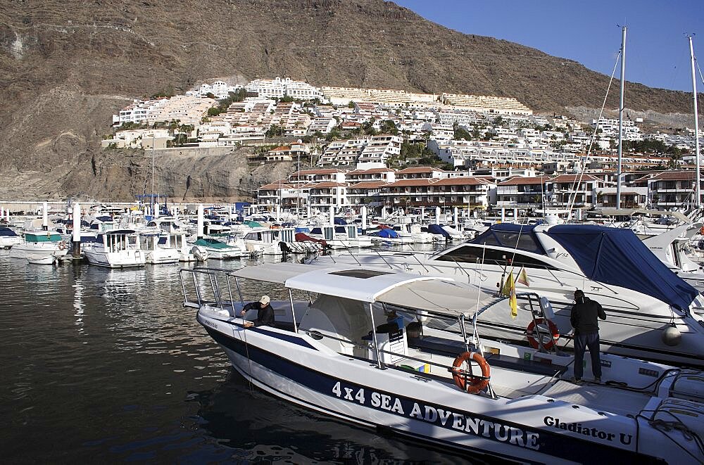 Spain, Canary Islands, Tenerife, Los Gigantes view across marina with boats moored.