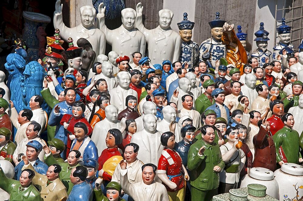 China, Shanghai, Porcelain figurines mainly of Chairman Mao Zedong but also of other Chinese communist leaders and Emperors and courtiers Memorabilia on sale at Dongtai antique market.