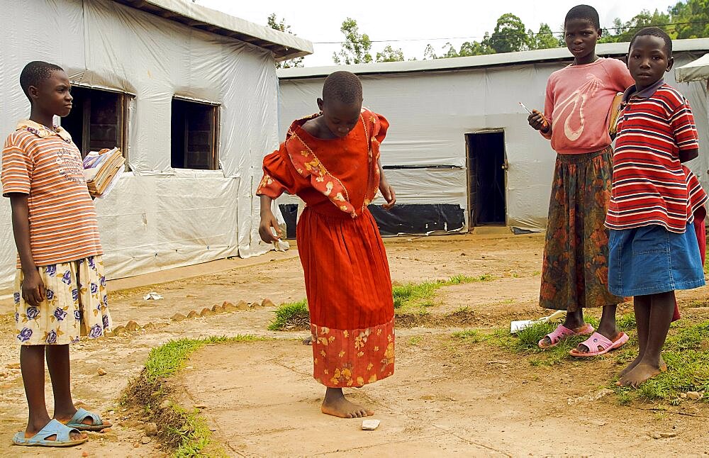 Burundi, Cibitoke Province, Mabayi, Primary School Girls playing hopscotch beside the Catch-up Class for children who have dropped out of school. Concern Worldwide has supported the establishment of a number of classes.