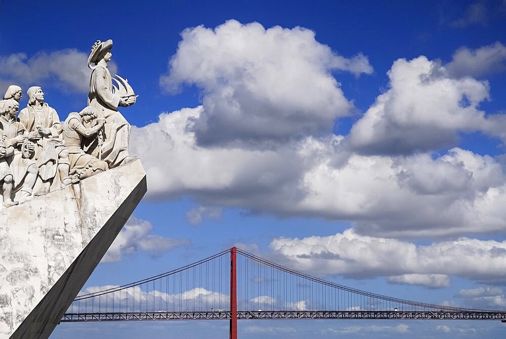 Portugal, Estremadura, Lisbon, Padrao dos Descobrimentos Carving of Prince Henry the Navigator leading the Discoveries Monument with the Ponte 25th Abril Bridge behind.