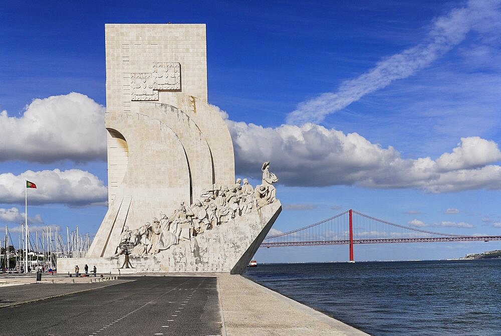 Portugal, Estremadura, Lisbon, Padrao dos Descobrimentos Carving of Prince Henry the Navigator leading the Discoveries Monument with the Ponte 25th Abril Bridge behind.