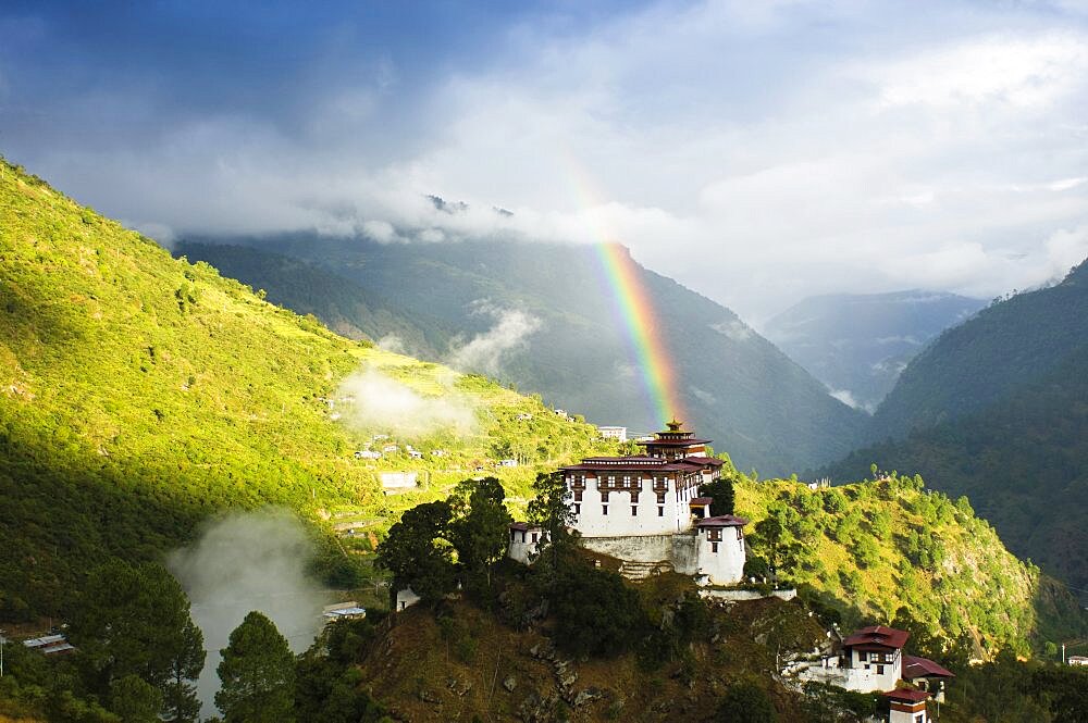 Bhutan, Lhuentse Dzong, Lhuentse Dzong with colourful rainbow overhead.