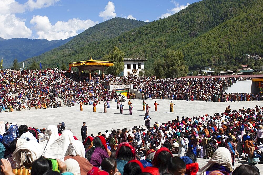 Bhutan, Thimpu Dzong, Dancers in the courtyard during festival.