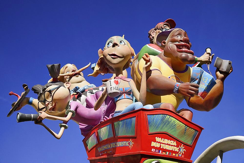 Spain, Valencia Province, Valencia, Las Fallas scene with Papier Mache figures on a Bus Turistic in Plaza Ayuntamiento during Las Fallas festival.