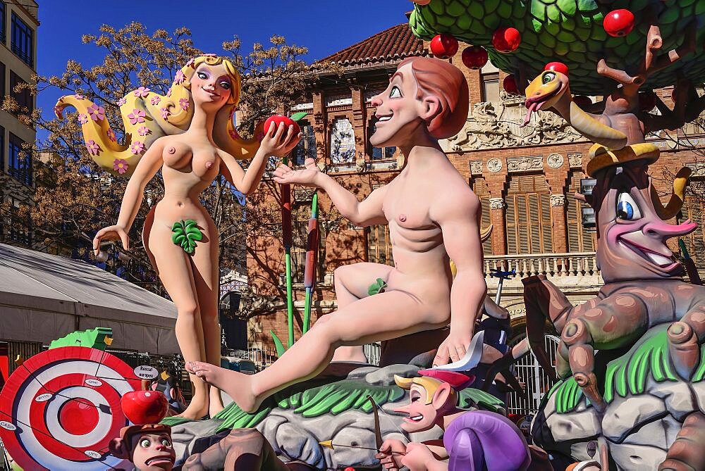 Spain, Valencia Province, Valencia, Papier Mache figures of Adam and Eve in the garden during Las Fallas festival.