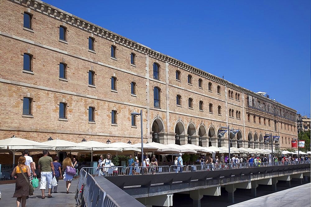 Spain, Catalonia, Barcelona, Tourists walking along promenade next to Museu D'Historia De Catalunya.