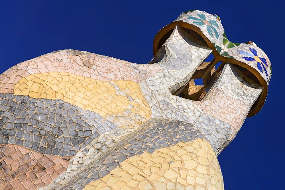 Spain, Catalunya, Barcelona, Antoni Gaudi's Casa Batllo building, colourful chimney pots on the roof terrace.