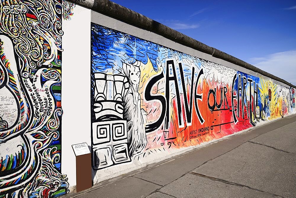 Germany, Berlin, The East Side Gallery, a 1.3 km long section of the Berlin Wall, Mural known as Save our Earth by Artist Indiano.