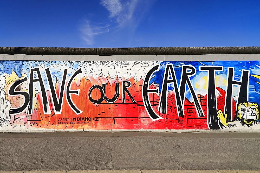 Germany, Berlin, The East Side Gallery, a 1.3 km long section of the Berlin Wall, Mural known as Save our Earth by Artist Indiano.