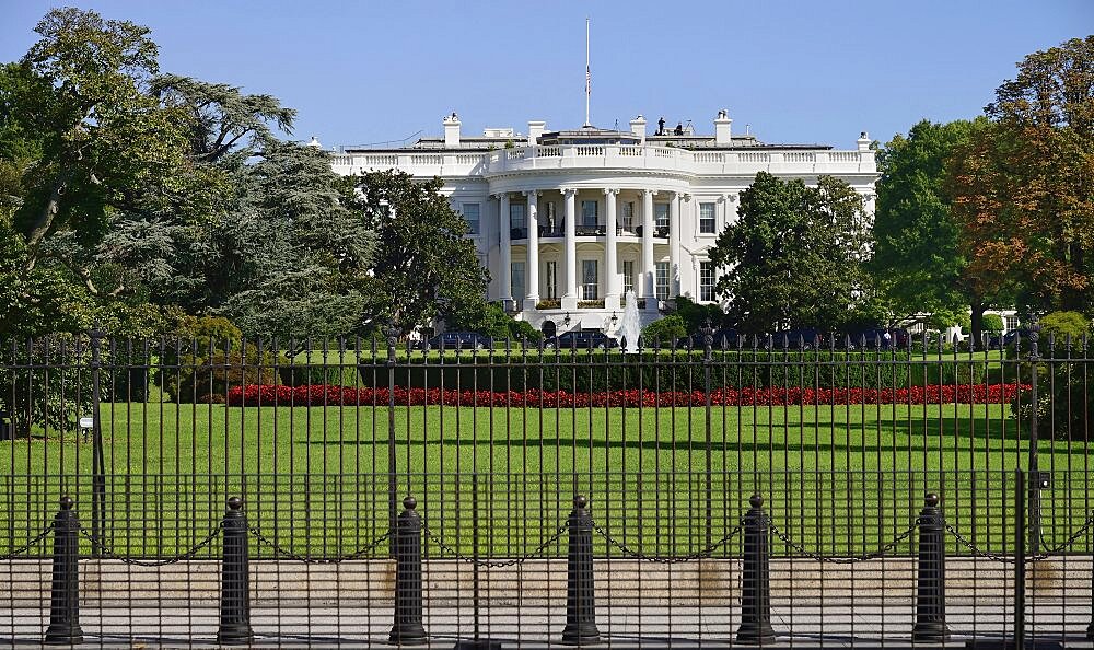 USA, Washington DC, South Portico of the White House with the Stars and Stripes flag flying at half mast.