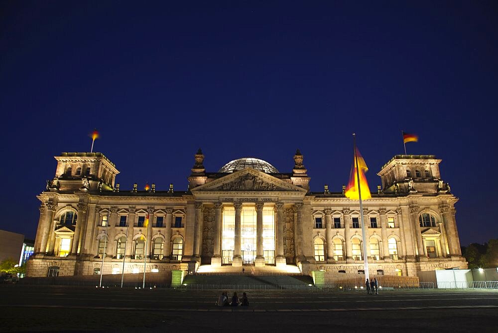 Germany, Berlin, Mitte, Reichstag building with glass dome deisgned by Norman Foster, illuminated at night.