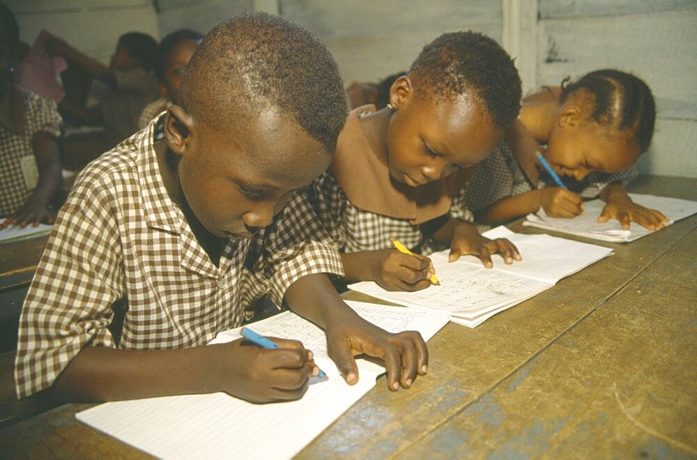 GHANA  Accra Primary school pupils writing at their desks.