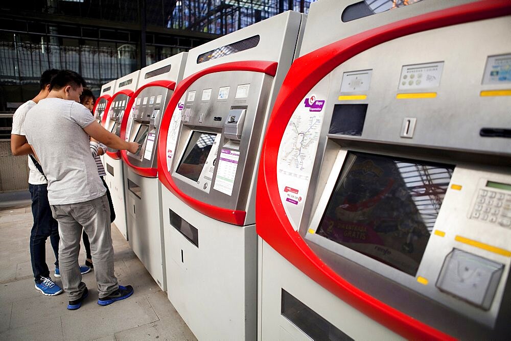 Spain, Madrid, Self-service ticket machines at Principe Pio metro station.