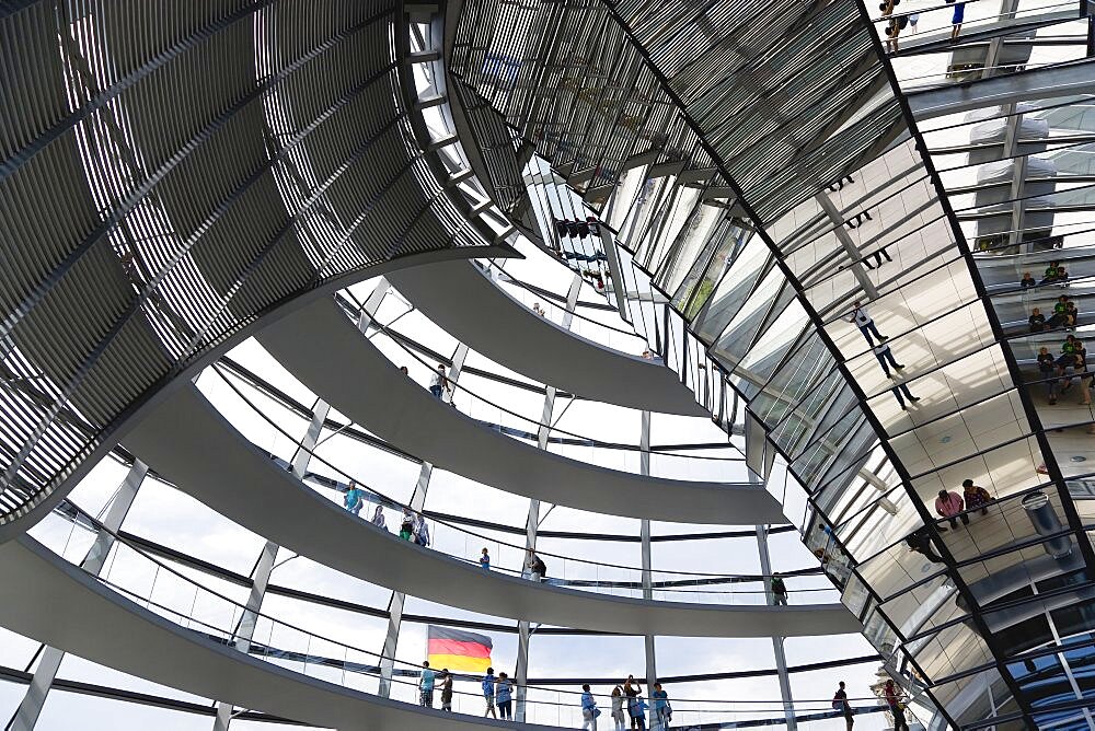 Germany, Berlin, Mitte, Tiergarten, interior of the glass dome on the top of the Reichstag building designed by architect Norman Foster with a double-helix spiral ramp around the mirrored cone that reflect light into the debating chamber of the Bundestag below.