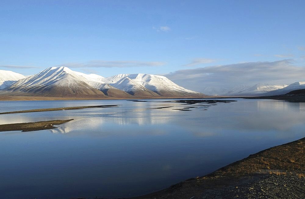 Norway, Svalbard, Longyearbyen, View across Adventfjorden toward snow capped mountain.