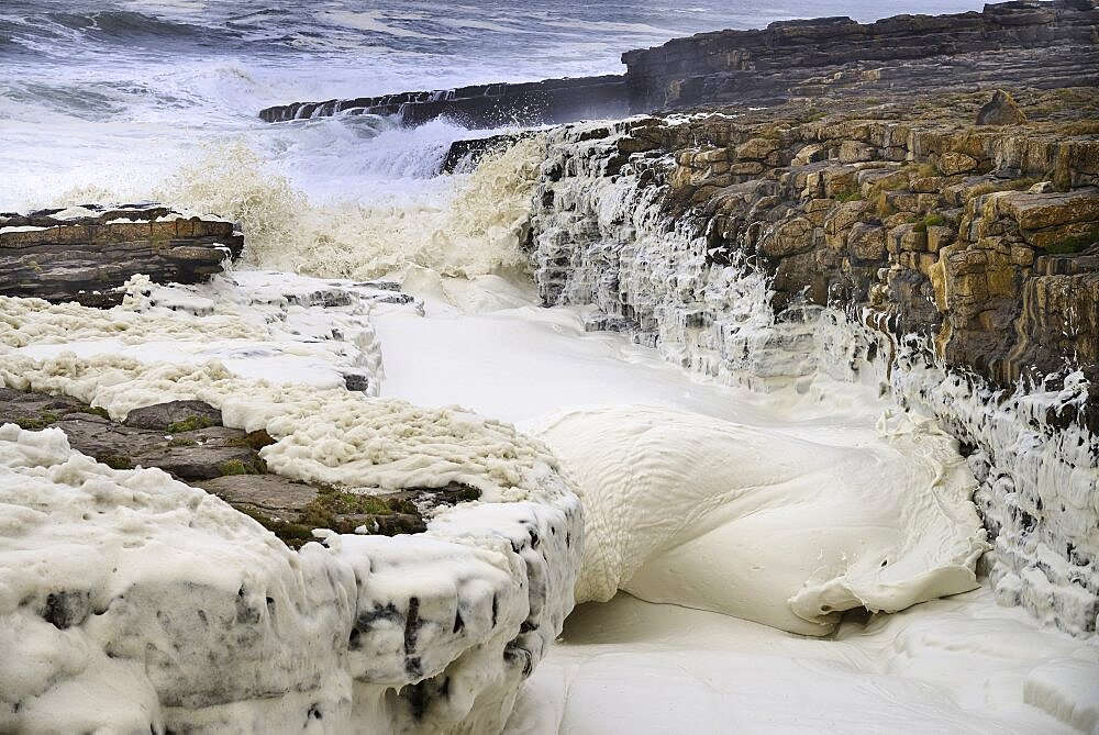 Ireland, County Sligo, Streedagh,  Foam being generated by stormy seas.