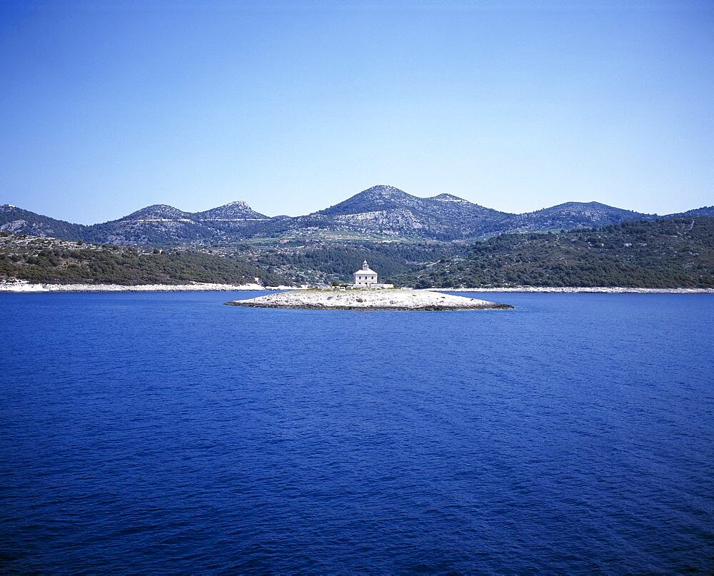 CROATIA  Dalmatia View over water toward small islet between Sibenik and Trogir with lighthouse in the centre  Center   Center