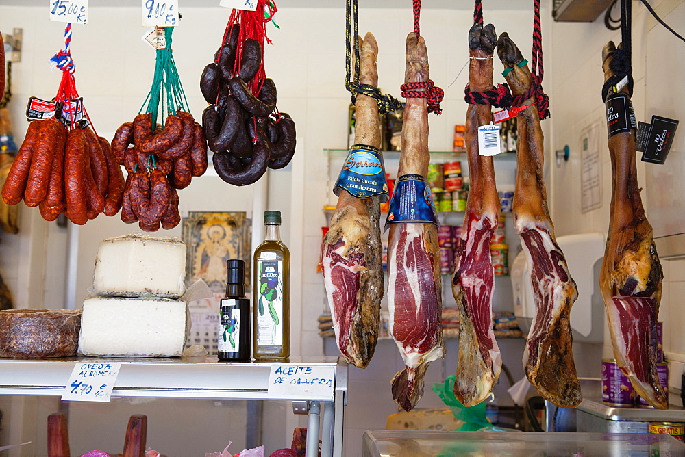 Spain, Andalucia, Cadiz, Display of jamon, chorizo & cheese at a carniceria in the Central Market.