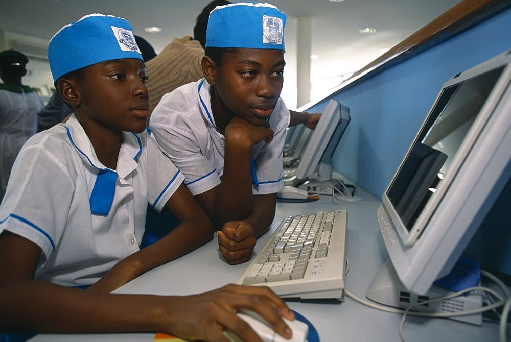 NIGERIA  Abuja Two children in uniform working on a computer at the British Council African Kids Learning Lessons Nigerian Teaching Western Africa 2