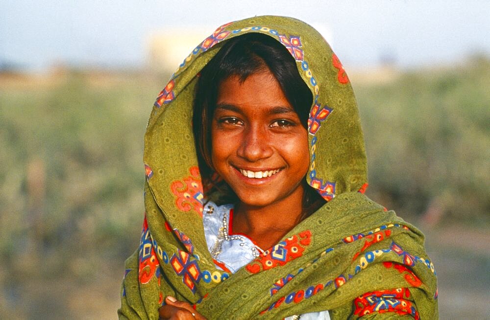 PAKISTAN Sindh Province General Portrait of smiling Gypsy girl.  romany