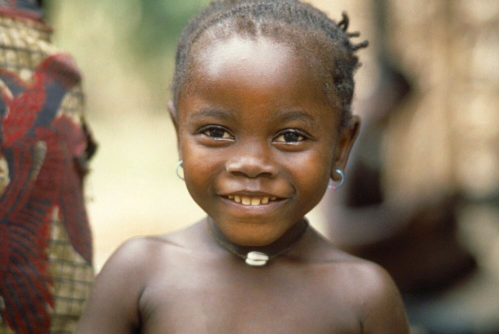 SIERRA LEONE People Children Head and shoulders portrait of young Mende girl smiling .