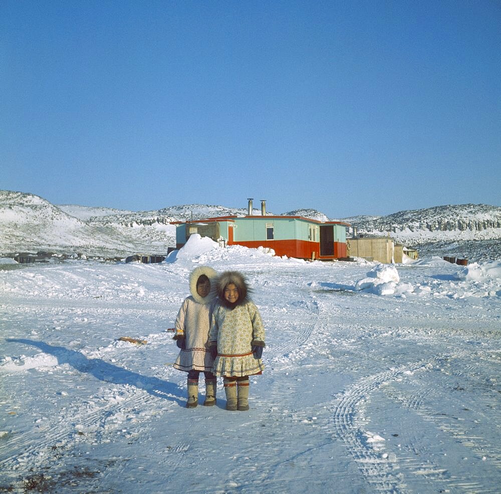 CANADA Nunavut Baffin Island Young Innuit girls outside settlement.