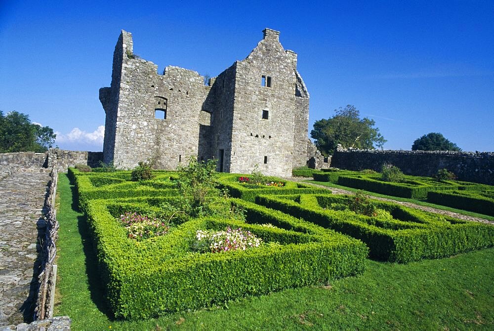 NORTHERN IRELAND Fermanagh Tully Tully Castle. Ruins of a fortified plantation house dating from 1610 with recently planted early 17th century style formal garden