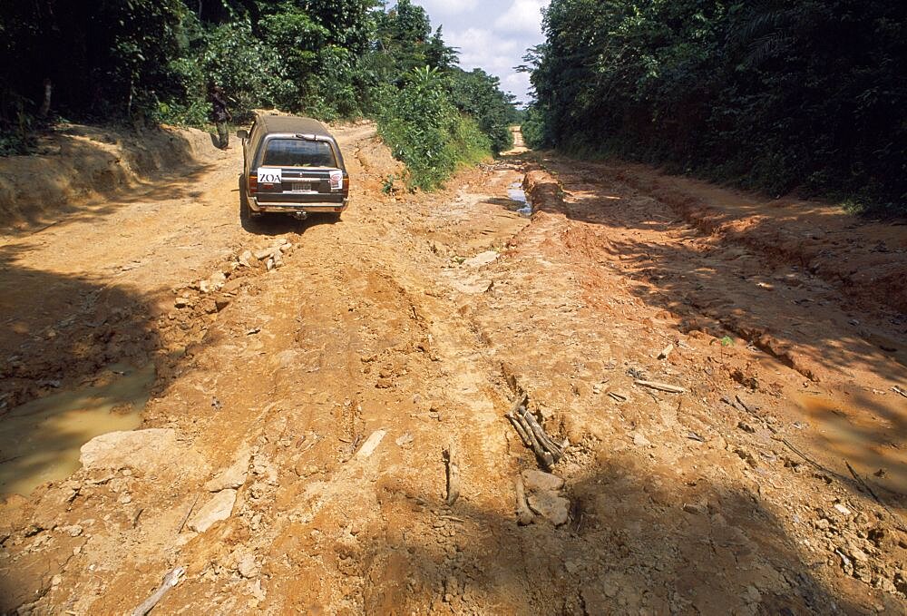 LIBERIA    Nimba Zinakopa Car on unmade road with deep ruts through mud in foreground.    Automobile   Automobile