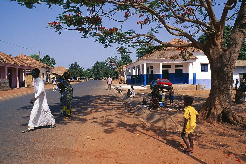 GUINEA BISSAU  San Domingos Street scene with people and roadside vendor in town in the Casheu region.