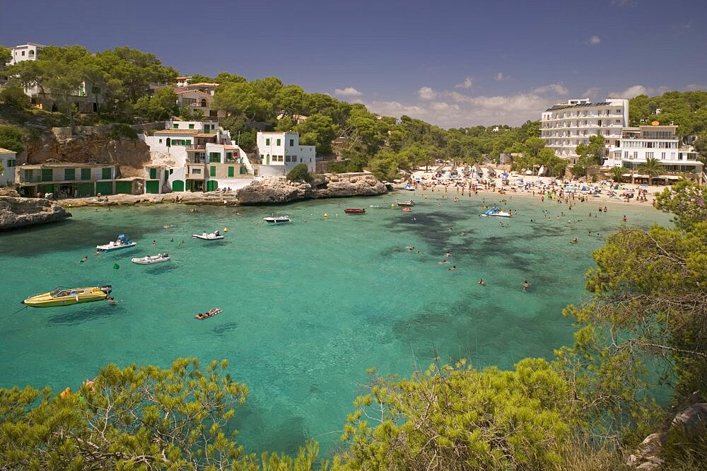 SPAIN Mallorca Cala Santany View of the beach with boats on the clear water. Majorca Mediterranean Holidays Tourism Travel Beach Seaside Sun bathing