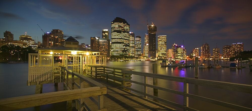 AUSTRALIA Brisbane View from a pier  of the CBD across the Brisbane River at dusk with boats on one side. Tourism  Travel  Holidays  State Capital  Panorama  Skyline  Skyscrapers  Night Time exposure  Central Business Distrtict