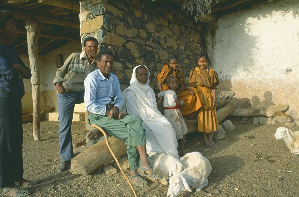 ERITREA  Seraye Province Farming family outside home with sheep.